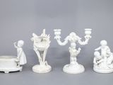 cinq figurines blanches posées les unes à côté des autres sur une table
