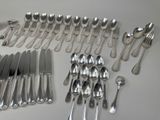 a lot of silver spoons and forks laid out on a table