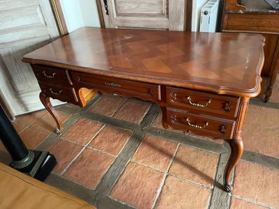 a wooden desk with two drawers on top of it