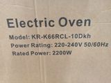 an electric oven sitting on top of a cardboard box on top of a table