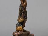 bronze statue of a woman with a basket of fruit on a marble base