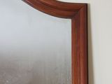 a mirror that is hanging on a wall in a room