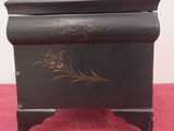 a small black box with gold designs on it
