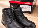 a pair of black boots sitting on top of a wooden floor
