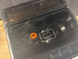 a black toaster sitting on top of a wooden table