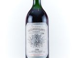 the bottle of wine is sitting on a white surface
