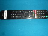 a remote control that is sitting on a blue surface