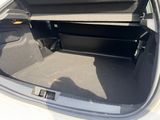 the trunk of a car with the door open and the seat folded down