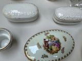 a white table with a plate and bowls on it