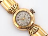 an image of a close up of a wrist watch on a white surface