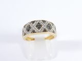 a close up of a gold ring with black and white diamonds