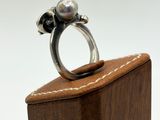 a ring that is sitting on top of a wooden box