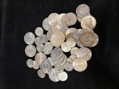 a pile of silver coins on a black background