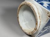 a blue and white vase sitting on a table