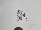 an image of a close up of a white vase with a black and white label