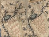 a close up of a piece of cloth with a bird on it