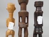 three wooden sculptures of different shapes and sizes on a gray background