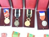 several medals are displayed in a display case on a white surface