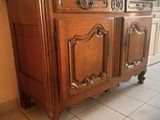 a wooden cabinet that is sitting on a tiled floor