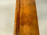 an old wooden box with a wooden handle on a white background