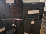 two computers sitting on top of a desk next to each other