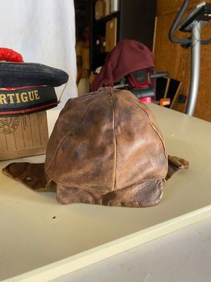 un chapeau marron posé sur une table blanche