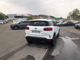 a white car that is parked in a parking lot
