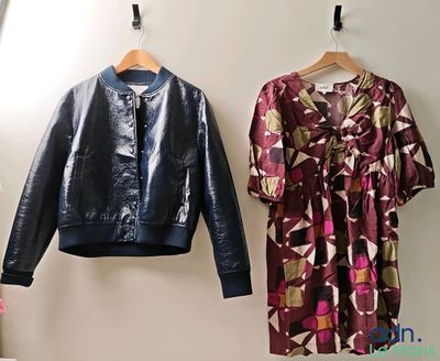 two jackets hanging on the wall next to each other