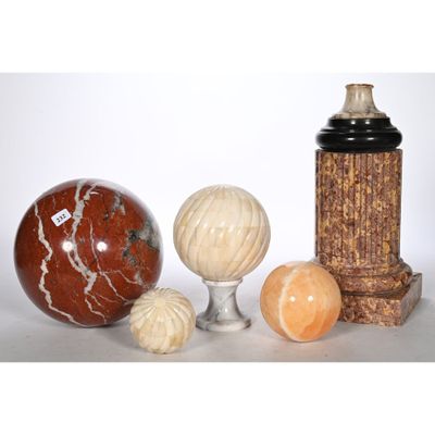 three vases and three balls on a table