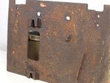 a rusted metal plate with a hole in the middle