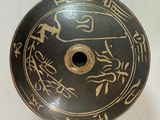 a black and gold plate with asian writing on it