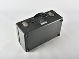 a small black suitcase sitting on a white surface