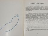 someone is holding a book with a drawing of a bird on it