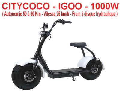 a white scooter sitting on top of a white floor next to a white wall