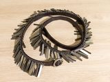 two leather bracelets with metal spikes on a wooden surface