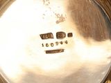 a close up of a silver plate with a clock on it