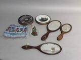 a table with a mirror, a mirror, and other items on it
