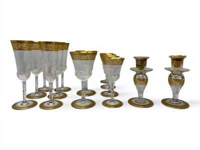 a group of wine glasses and a candle holder on the table