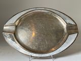 a silver plate that is sitting on a stand