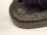 a statue of a dog that is sitting on top of a base