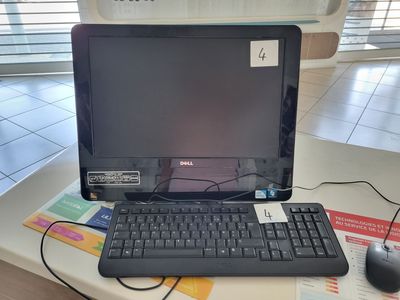 a laptop computer sitting on a desk with a keyboard and mouse