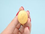 a person holding a gold coin in their hand