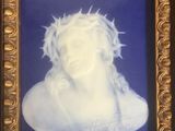 painting of jesus with crown of thorns in gold frame on blue background