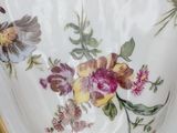 a plate with a floral design on it on a table