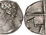a silver coin with an image of a woman and a cross on it