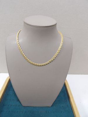 a close up of a mannequin with a gold chain on it