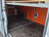 a white van with the door open and a shelf in the back