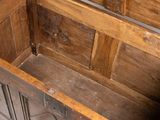 a wooden chest with a door open on a white floor