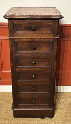 an image of a tall wooden chest of drawers with a marble top