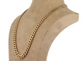 a gold chain necklace on a mannequin mannequin